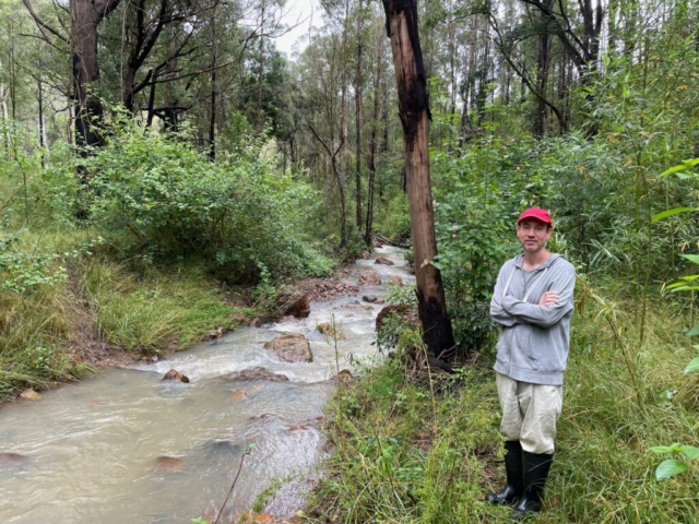 PB by the creek in his gumboots