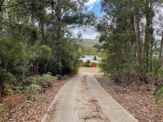 The end of the driveway with the house in the distance