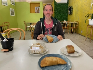 PB enjoys a healthy meal of fried empanada and cake