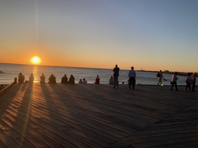 A crowd gathers to watch the sunset in Fremantle