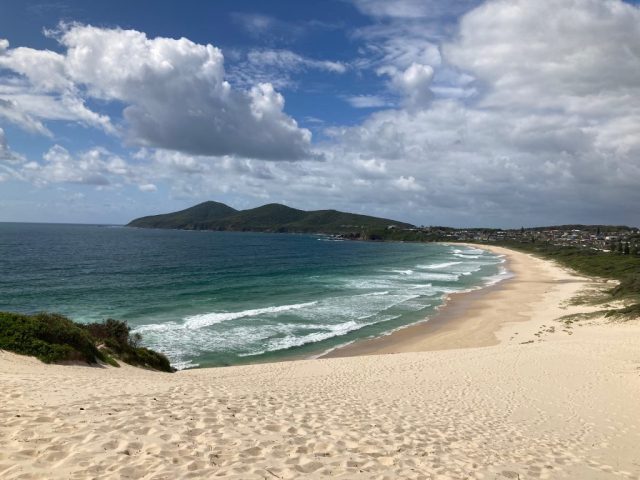 At the top of the sand dune on One Mile Beach
