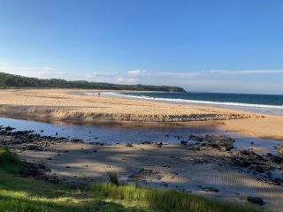 View over the inlet to Black Head Beach