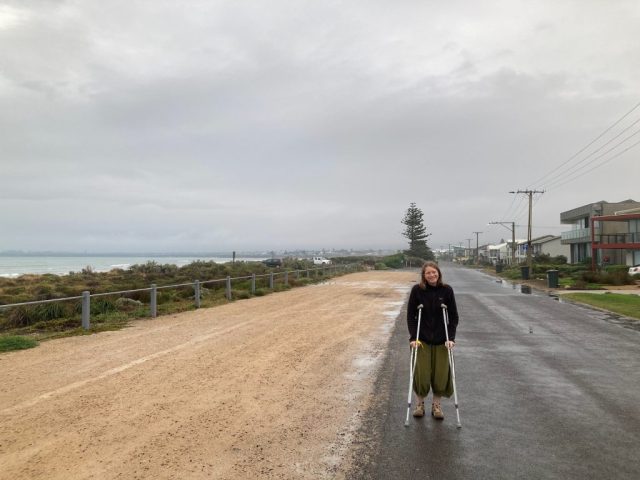 CC on a rainy coastal walk with crutches CC on a rainy coastal walk with crutches